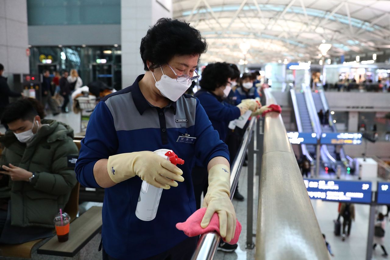 Disinfection workers wearing masks and spray anti-septic solution at the Incheon International Airport in South Korea. 