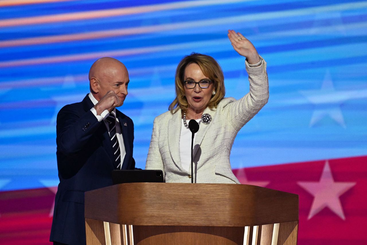 Former Rep. Gabby Giffords speaks on stage with her husband, Sen. Mark Kelly, during the DNC on Thursday, August 22, in Chicago.