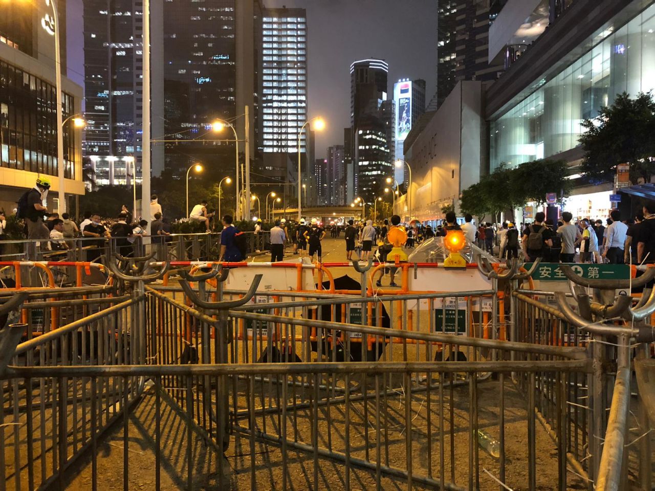 Barricades by Pacific Place where crowds of protesters are gathered. 