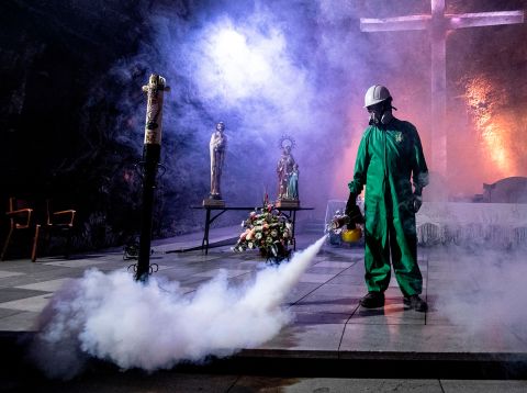 A worker disinfects the Salt Cathedral of Zipaquira, an underground church built into a salt mine, in Zipaquira, 45 km north of Bogota, on August 30.