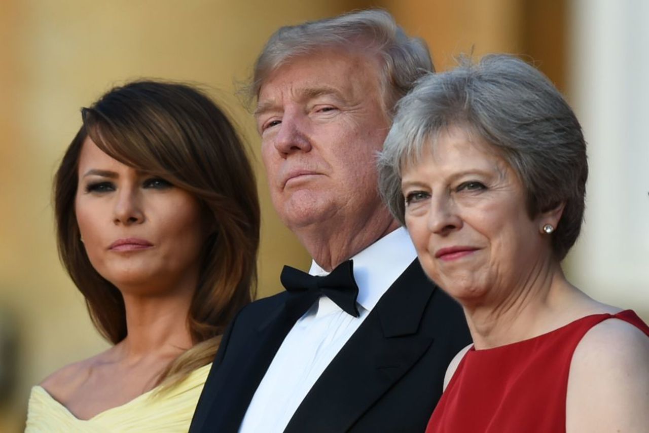 First lady Melania Trump, US President Donald Trump and Britain's Prime Minister Theresa May stand on the steps of the Great Court at Blenheim Palace on July 12, 2018. 