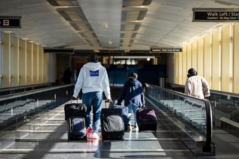 Travelers carry luggage as they arrive at Ronald Reagan Washington National Airport November 23, in Arlington, Virginia. 