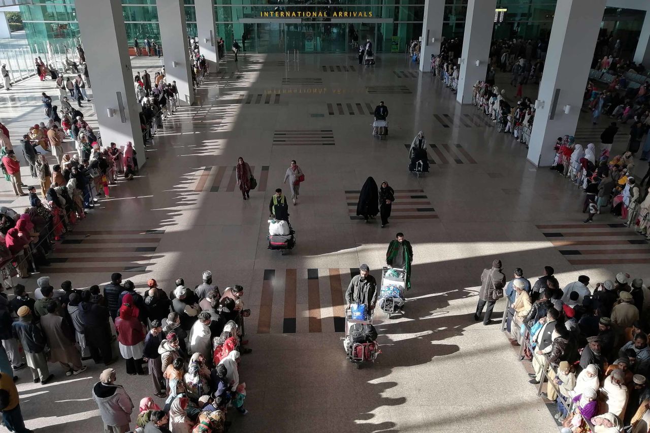 People gather to receive arriving passengers at the Islamabad International Airport in Pakistan on Monday.