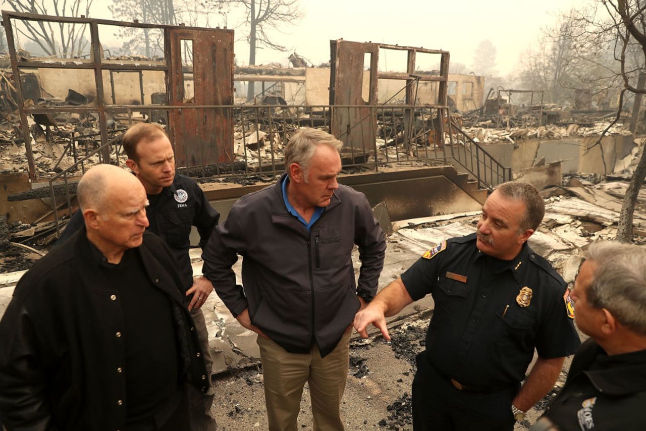 California Gov. Jerry Brown, FEMA Administrator Brock Long and US Secretary of the Interior Ryan Zinke tour a school burned by the Camp Fire on Nov. 14, 2018 in Paradise.