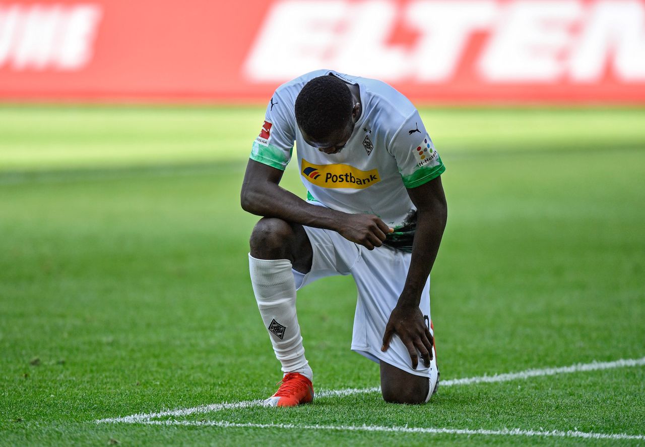 Borussia Möchengladbach forward Marcus Thuram takes a knee after scoring in the match between Möchengladbach and Union Berlin in Mönchengladbach, Germany, on May 31.