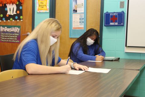 Keeping a seat between them, sophomores' Natalie Brantley, 15, left and Yareny Aguilar-Perez, 15, are introduced to the principles of Early Childhood I at Newton County Career and Technical Center in Decatur, Mississippi, on Monday, August 3.