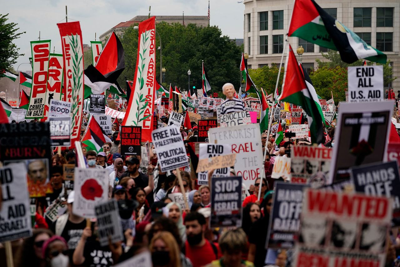 Demonstrators carry signs as they protest Israel Prime Minister Benjamin Netanyahu’s appearance before Congress.