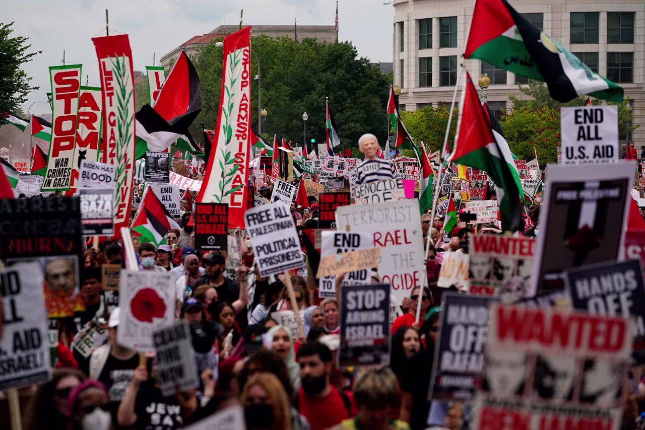 Demonstrators carry signs as they protest Israel Prime Minister Benjamin Netanyahu’s appearance before Congress.