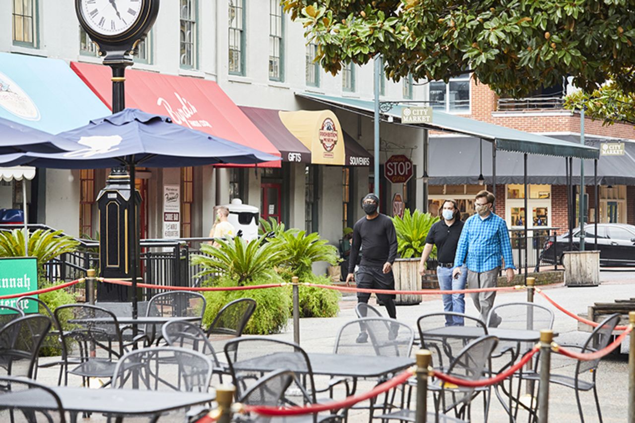 Pedestrians wearing protective masks walk through City Market in Savannah, Georgia, on Wednesday, August 19.