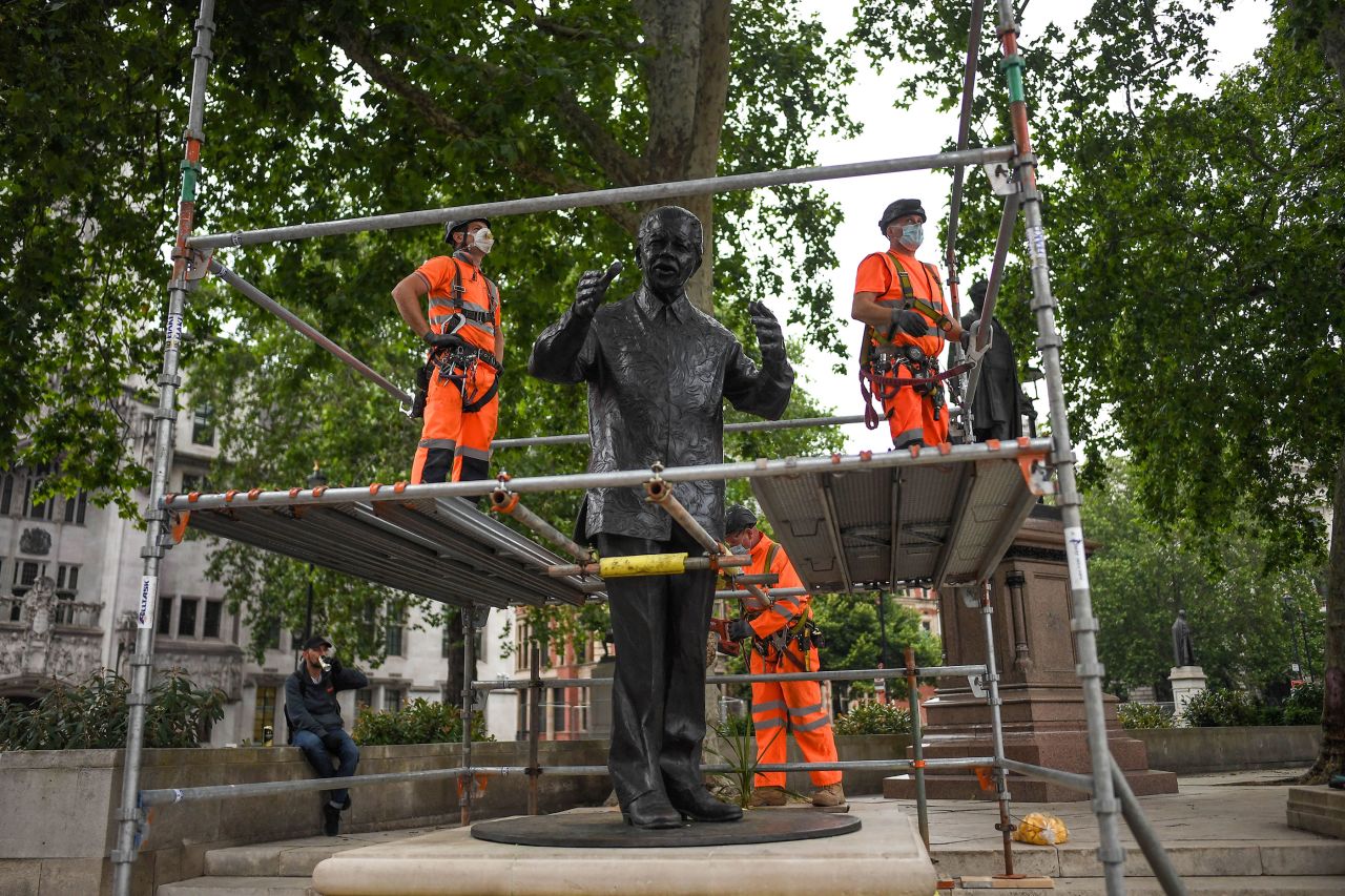 Workers build a protective barrier around the statue of Nelson Mandela in Parliament Square on June 12 in anticipation of protests on Saturday in London. 