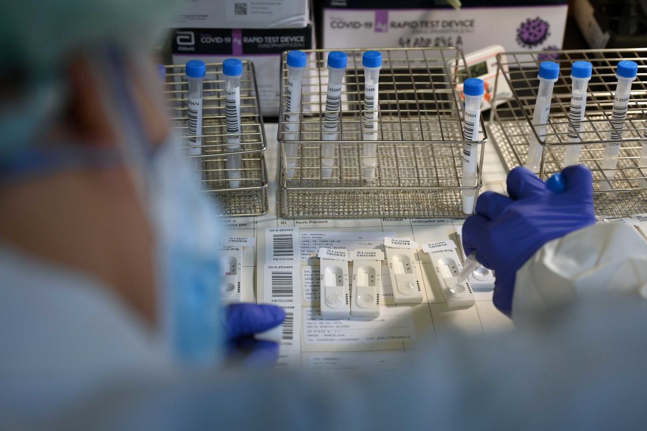 A healthcare worker conducts antigen rapid tests for COVID-19 during a mass coronavirus screening at a hospital in Barcelona, on December 14.