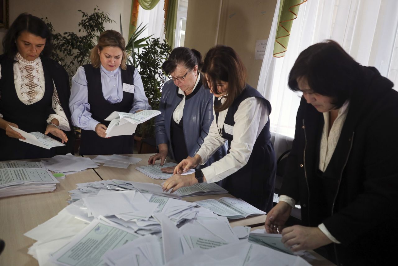 Members of an election commission count ballots at a polling station in Donetsk on September 27.