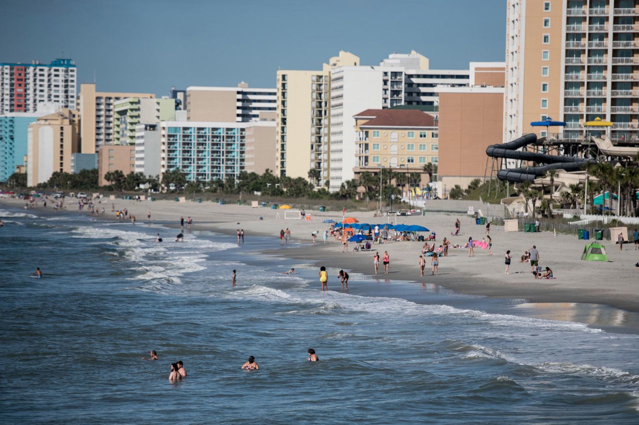 People wade in the surf on the morning of May 23 in Myrtle Beach, South Carolina. 