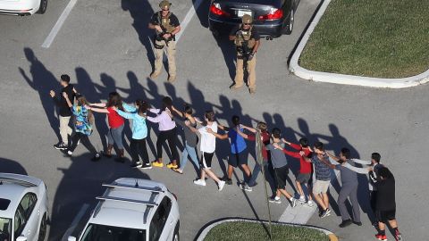 Students are brought out of Marjory Stoneman Douglas High School after the shooting on February 14, 2018.
