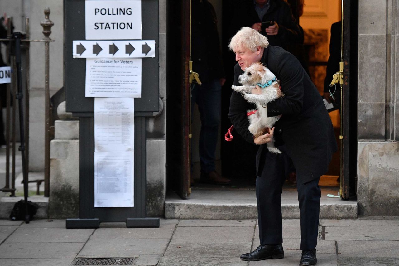 Prime Minister Boris Johnson poses with his dog Dilyn after casting his ballot at a polling station in central London on Thursday. Photo: Daniel Leal-Olivas/AFP via Getty Images