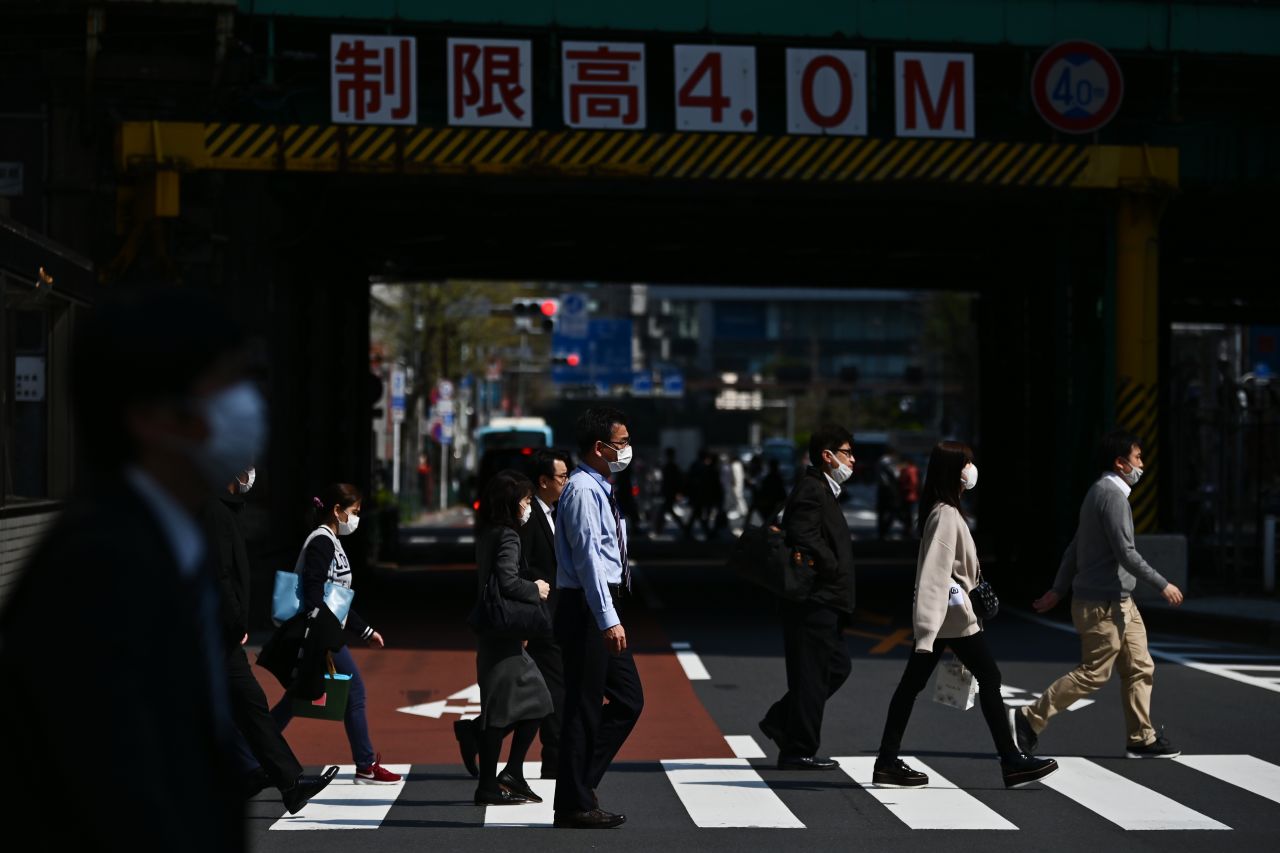 People cross a street in Tokyo on April 8.