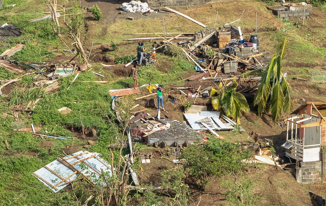 Family members survey their home destroyed in the passing of Hurricane Beryl, in Ottley Hall, St. Vincent and the Grenadines, on July 2.