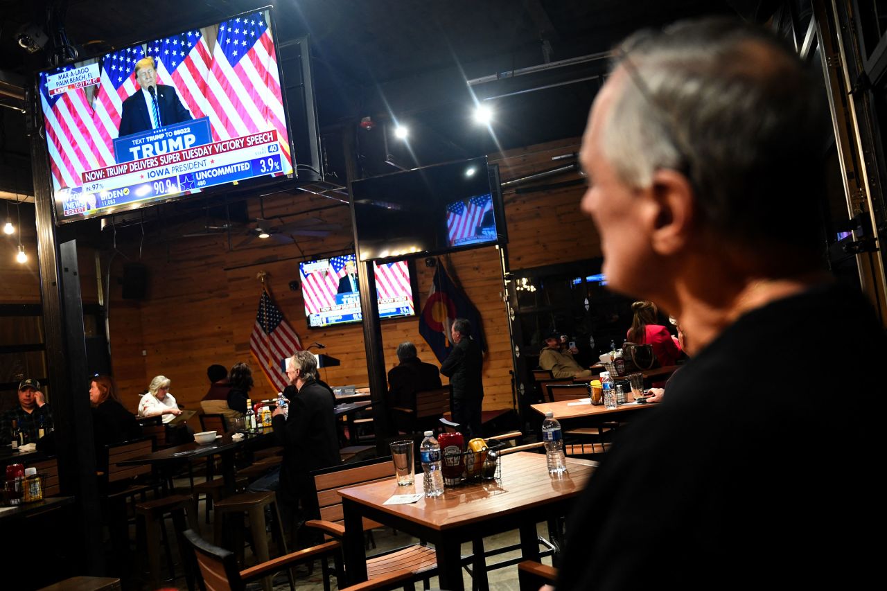 A supporter of former President Donald Trump watches a broadcast of his Super Tuesday victory speech during watch party at Wide Open Saloon in Sedalia, Colorado, on March 5.