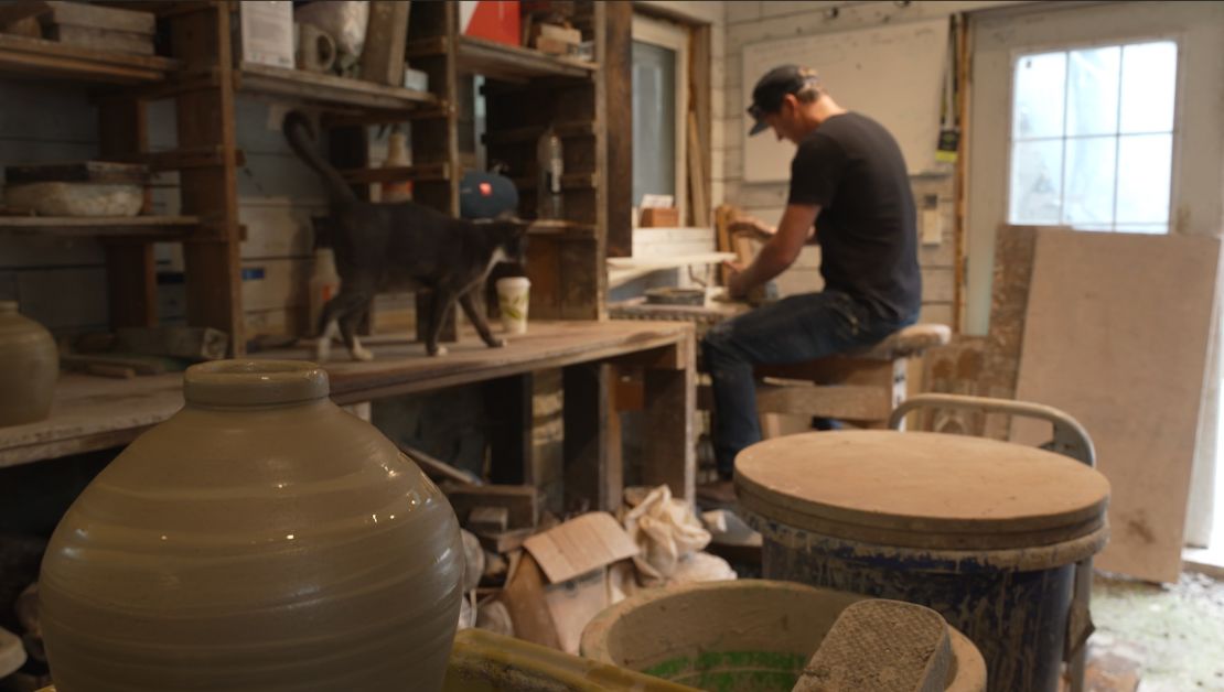Josh Copus, a potter who also owns the Old Marshall Jail Hotel, works in his ceramics studio just outside Marshall.