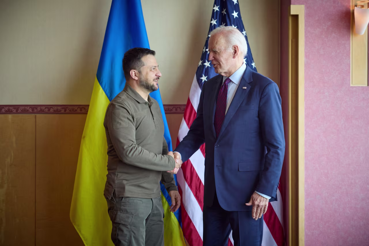 Zelensky and Biden shake hands in Hiroshima on Sunday.