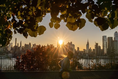 The sun rises above 42nd Street during a reverse 'Manhattanhenge' in New York, New York photographed from Weehawken, New Jersey on November 24, 2021. 