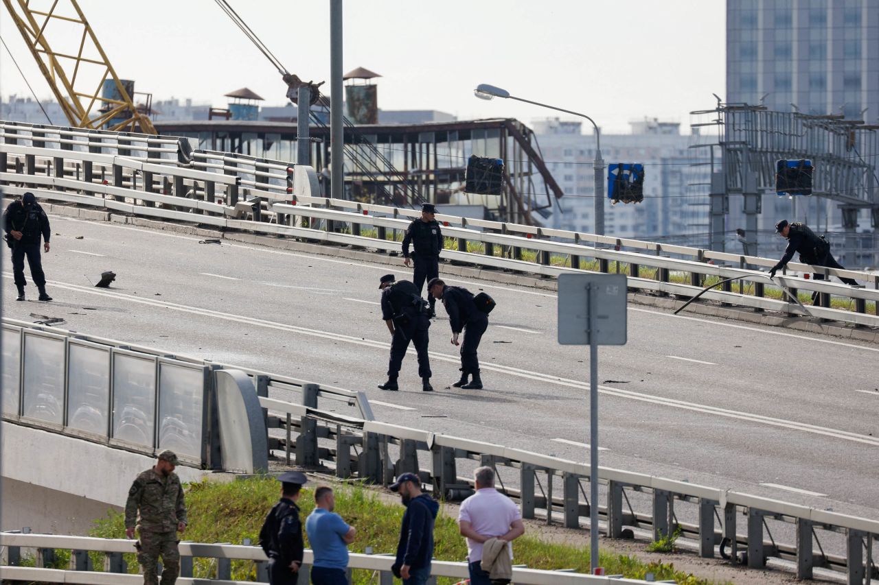 Members of the security services collect debris as they investigate near the site of a damaged building following a reported drone attack in?Moscow, Russia, on Monday, July 24. 