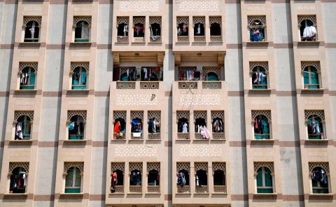 Residents hang their laundry off the railing on their balconies at their apartment building, to disinfect them under sunlight, in the city of Dubai on May 17.