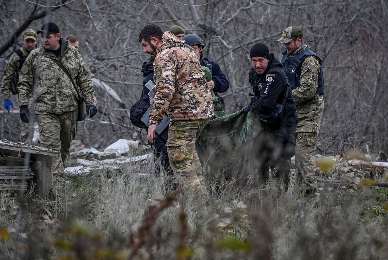 Police officers carry a body that was found under debris of a residential house destroyed by a Russian missile strike in the town of Vilniansk in the Zaporizhzhia region,?Ukraine, on November 17.