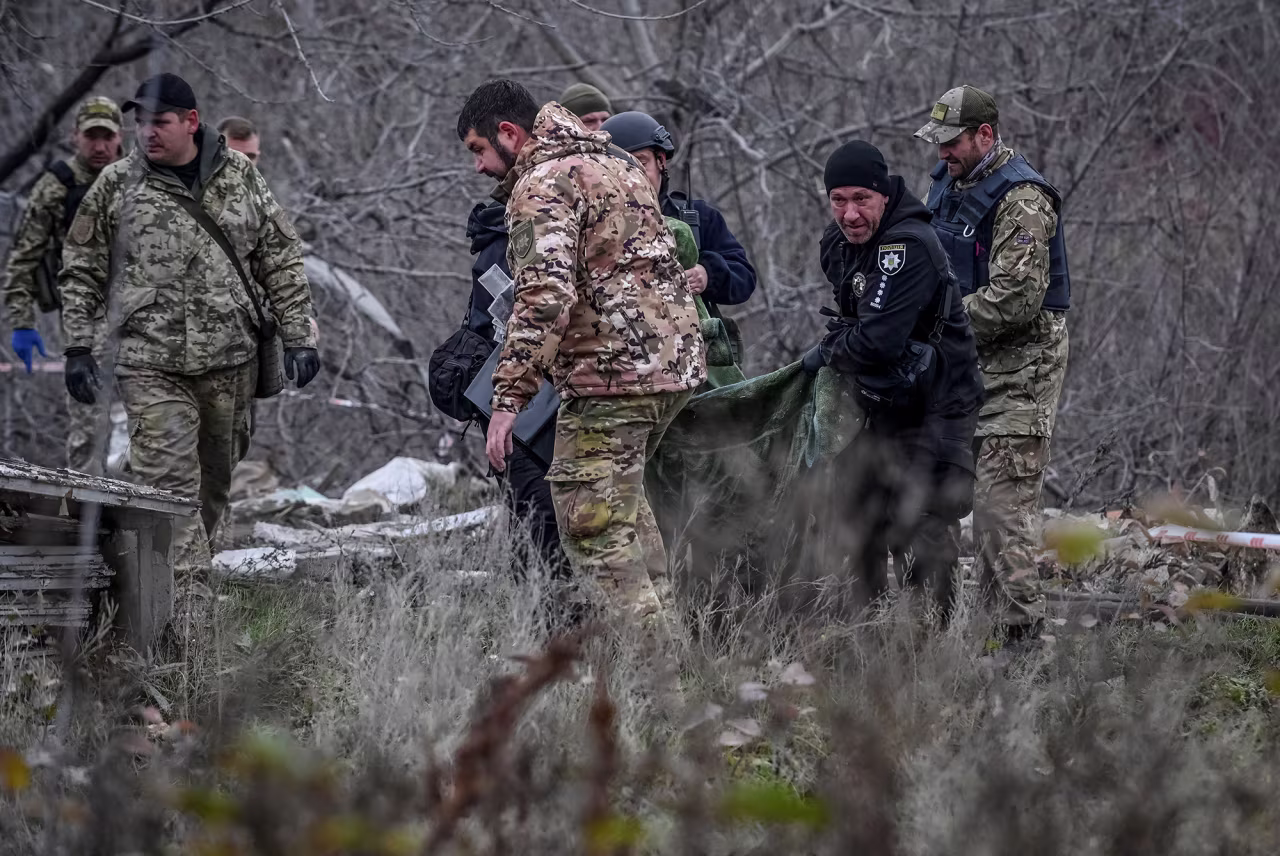 Police officers carry a body that was found under debris of a residential house destroyed by a Russian missile strike in the town of Vilniansk in the Zaporizhzhia region, Ukraine, on November 17.
