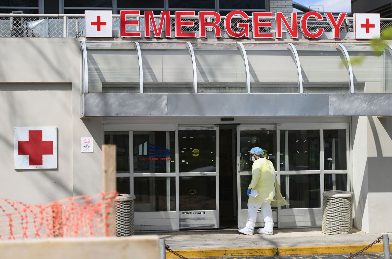 A medical worker enters the emergency room at a hospital in the Brooklyn borough of New York City, on April 15.