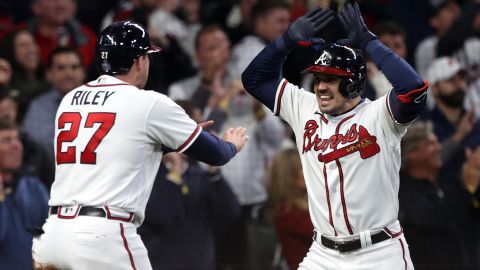 Adam Duvall, right, of the Braves is congratulated by Austin Riley after hitting a grand slam home run during the first inning.