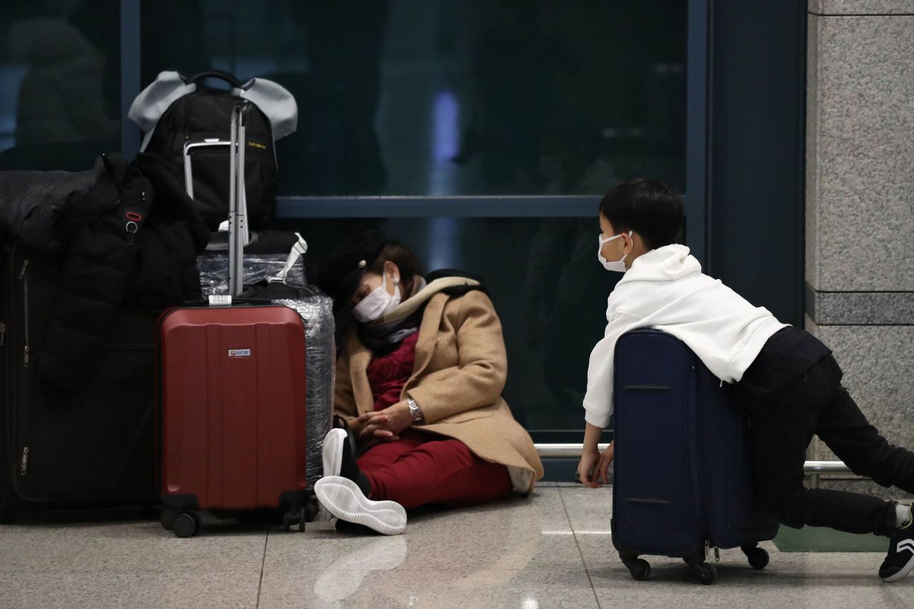 Travelers wearing masks are pictured at the Incheon International Airport in South Korea on January 27.