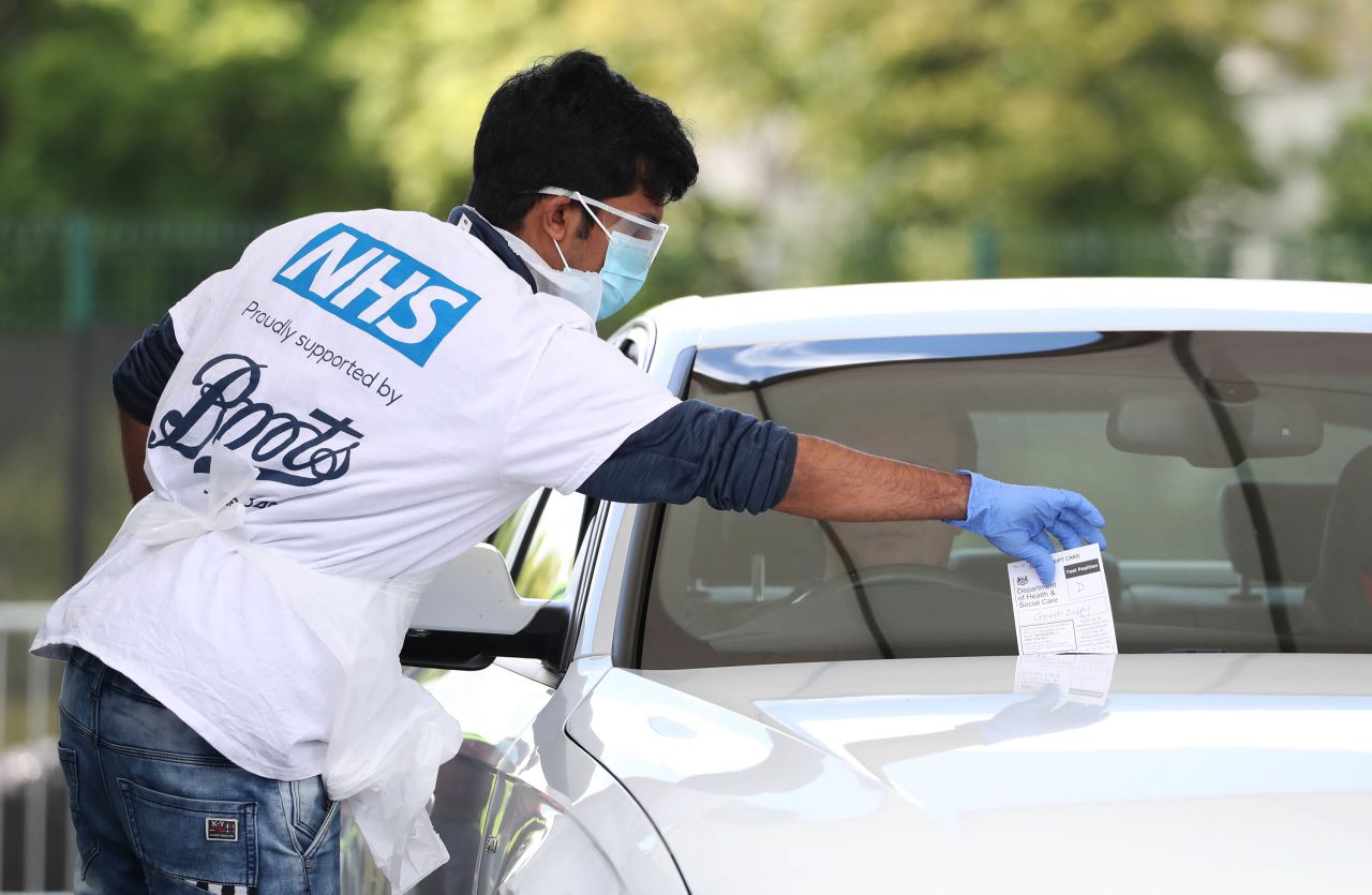 A driver is tested for the coronavirus at a drive-thru facility at the Edinburgh Airport in Scotland, on Friday, May 15. 