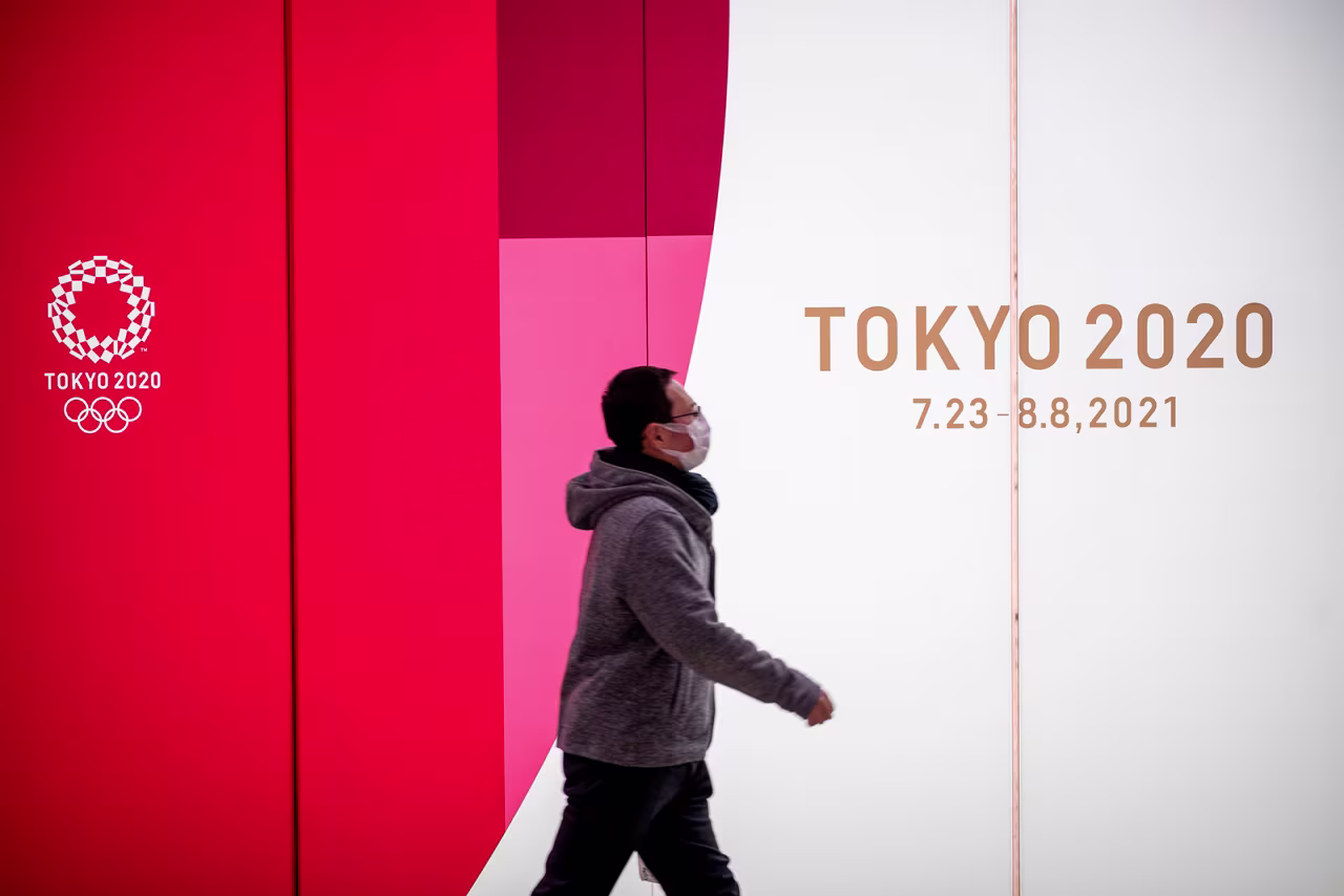 A man walks past Tokyo 2020 Olympic and Paralympic Games advertising in Tokyo's Shinjuku district on January 20.