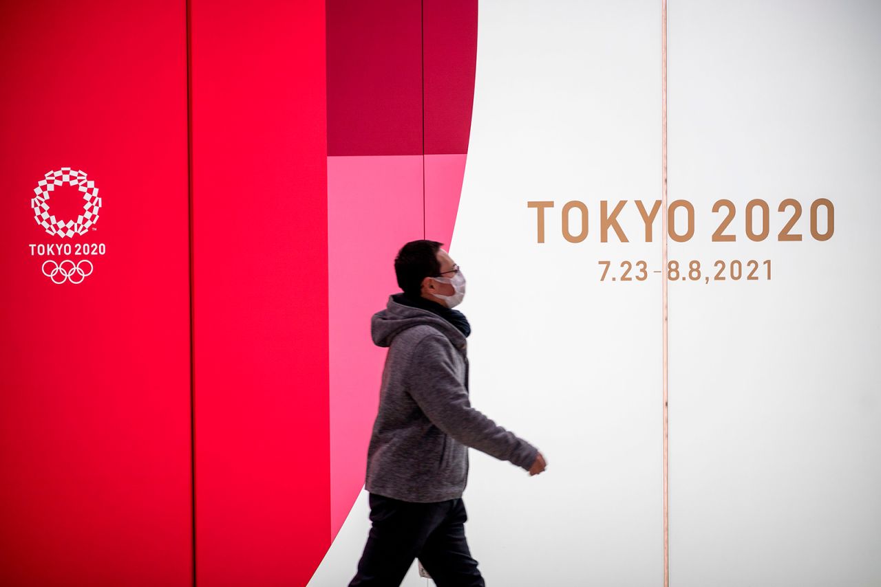 A man walks past Tokyo 2020 Olympic and Paralympic Games advertising in Tokyo's Shinjuku district on January 20.