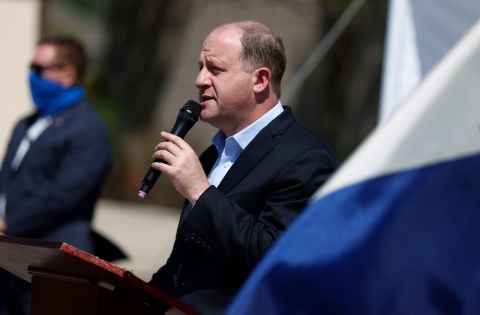 Colorado Governor Jared Polis makes a point about the state's efforts to rein in the new coronavirus during a news conference outside the Stride Community Health Center on Monday, May 18, in Wheat Ridge, Colorado.