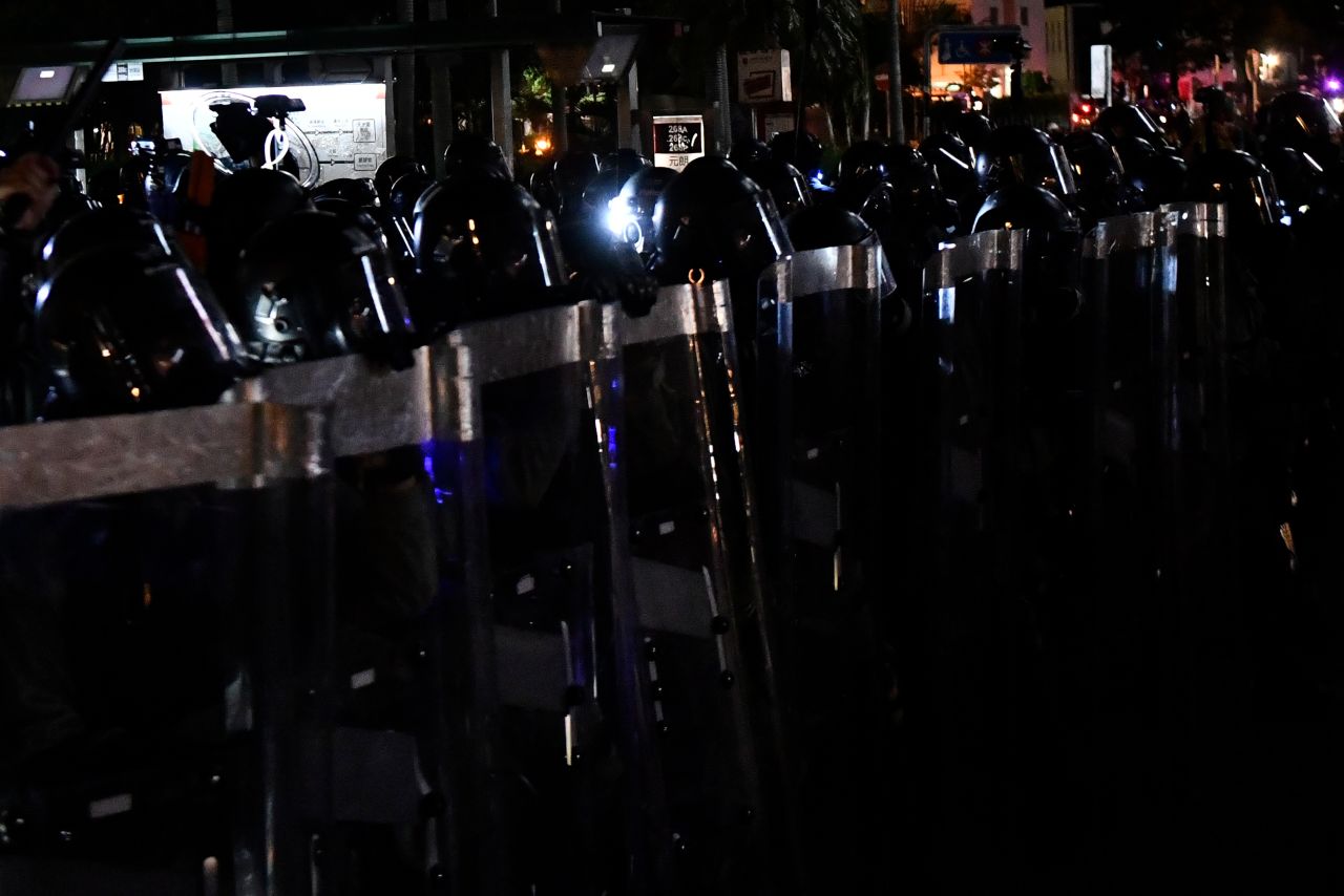 Police walk in a line as they attempt to disperse protesters in Wong Tai Sin during a general strike in Hong Kong on August 5.