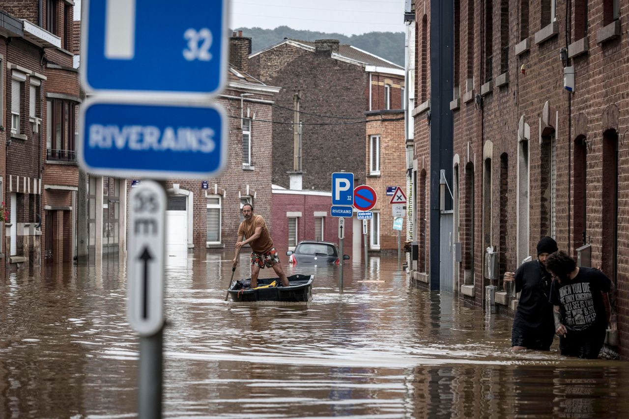 A man rows a boat down a residential street after flooding in Angleur, Province of Liege, Belgium, on July 16.