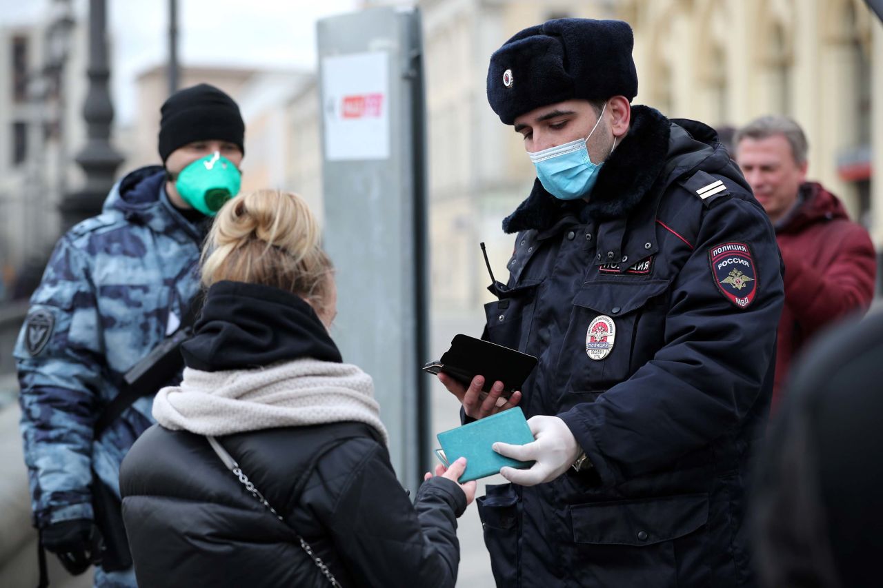 A police checks a commuter's documents at the entrance to a Moscow metro station on Wednesday.