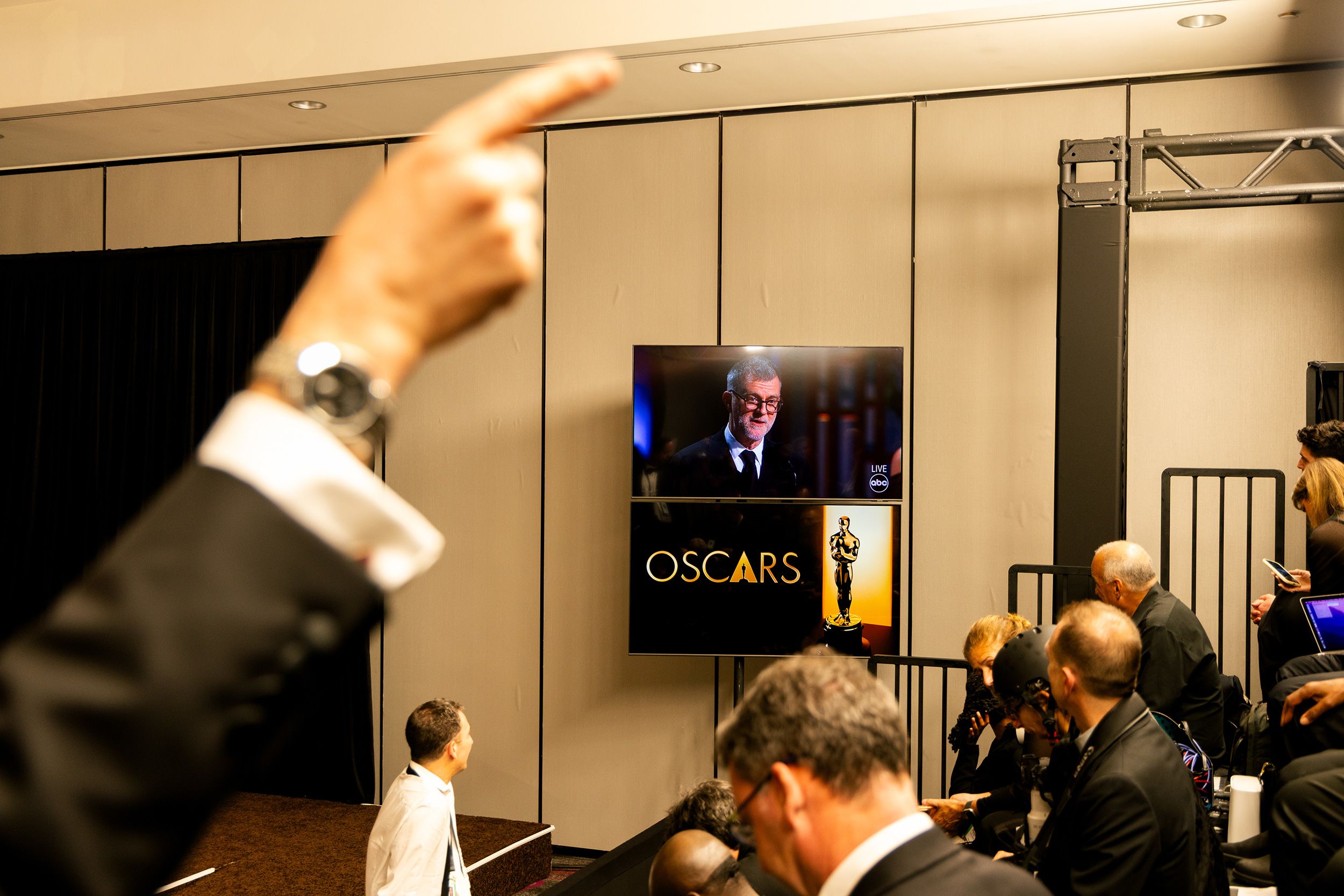 "One Battle After Another" director Paul Thomas Anderson is seen on a screen in the press room backstage. The film won best picture, best adapted screenplay and best director.