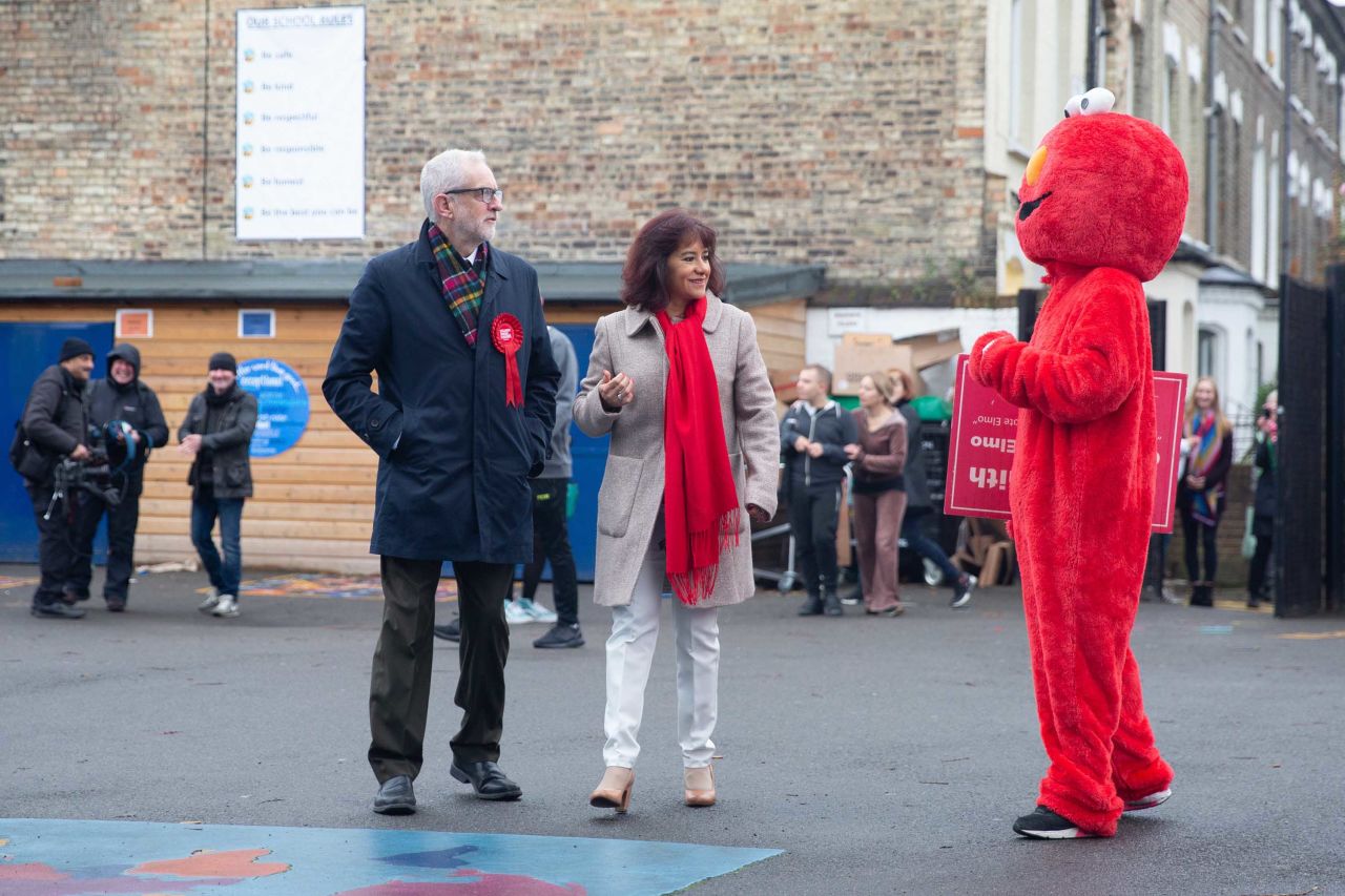 A person in an "Elmo" costume addresses Labour Party Leader Jeremy Corbyn at a polling station in London. Photo: Yunus Dalgic/Anadolu Agency via Getty Images