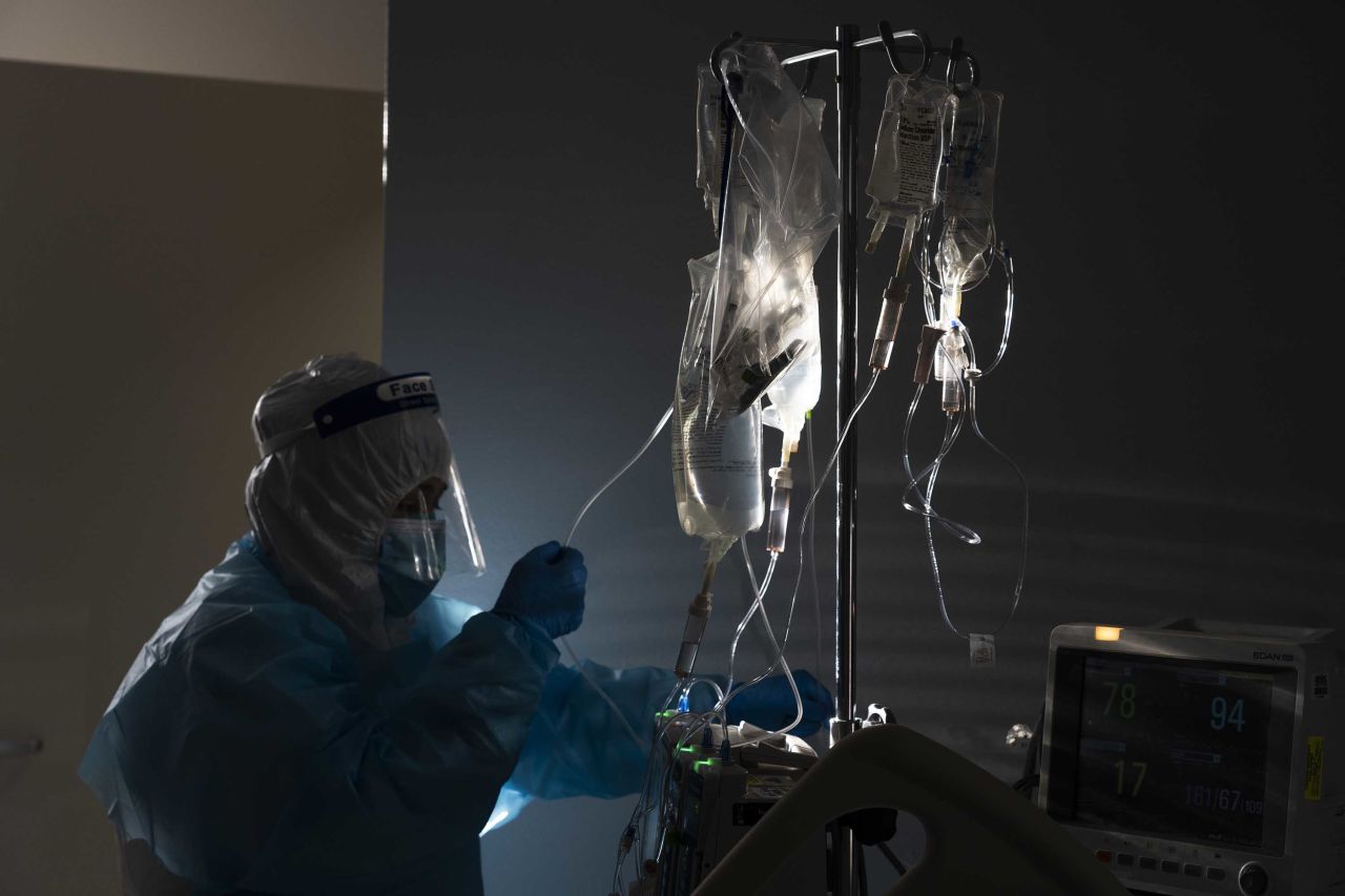 A medical staff member treats a patient suffering from the coronavirus disease at the United Memorial Medical Center in Houston, Texas, on November 14.