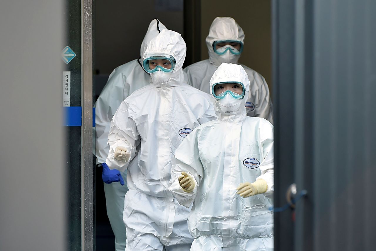 Medical staff members arrive for a duty shift at Dongsan Hospital in Daegu, South Korea, on Wednesday, March 18. 