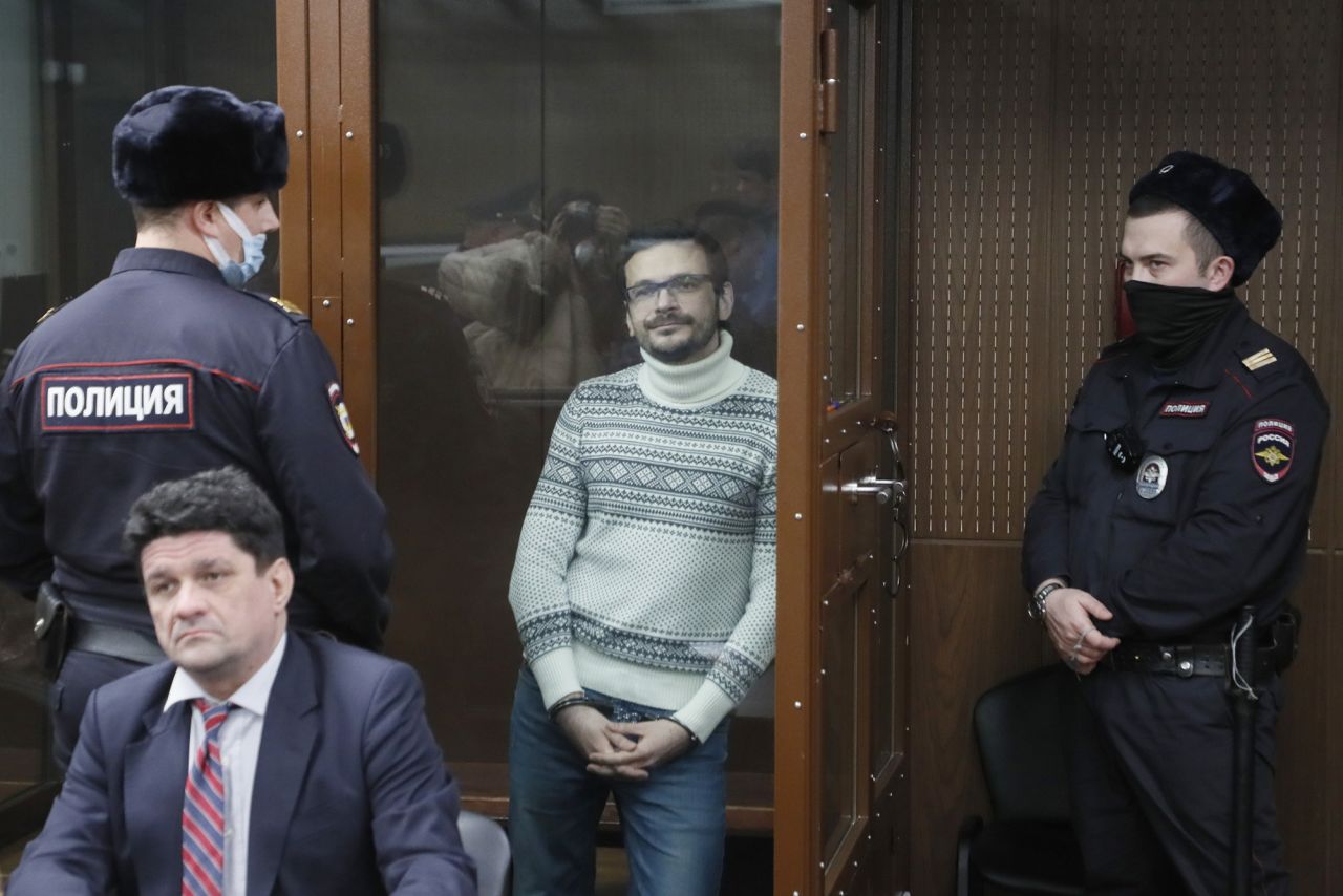 Russian opposition activist Ilya Yashin stands inside a glass cubicle in a courtroom, prior to a hearing in Moscow, Russia, on December 9.