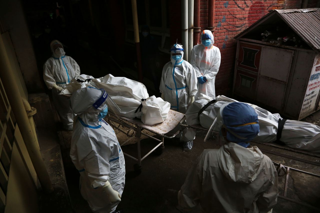 Paramedics get ready to load the bodies of Covid-19 victims into an ambulance for cremation in Kathmandu, Nepal, on May 12.