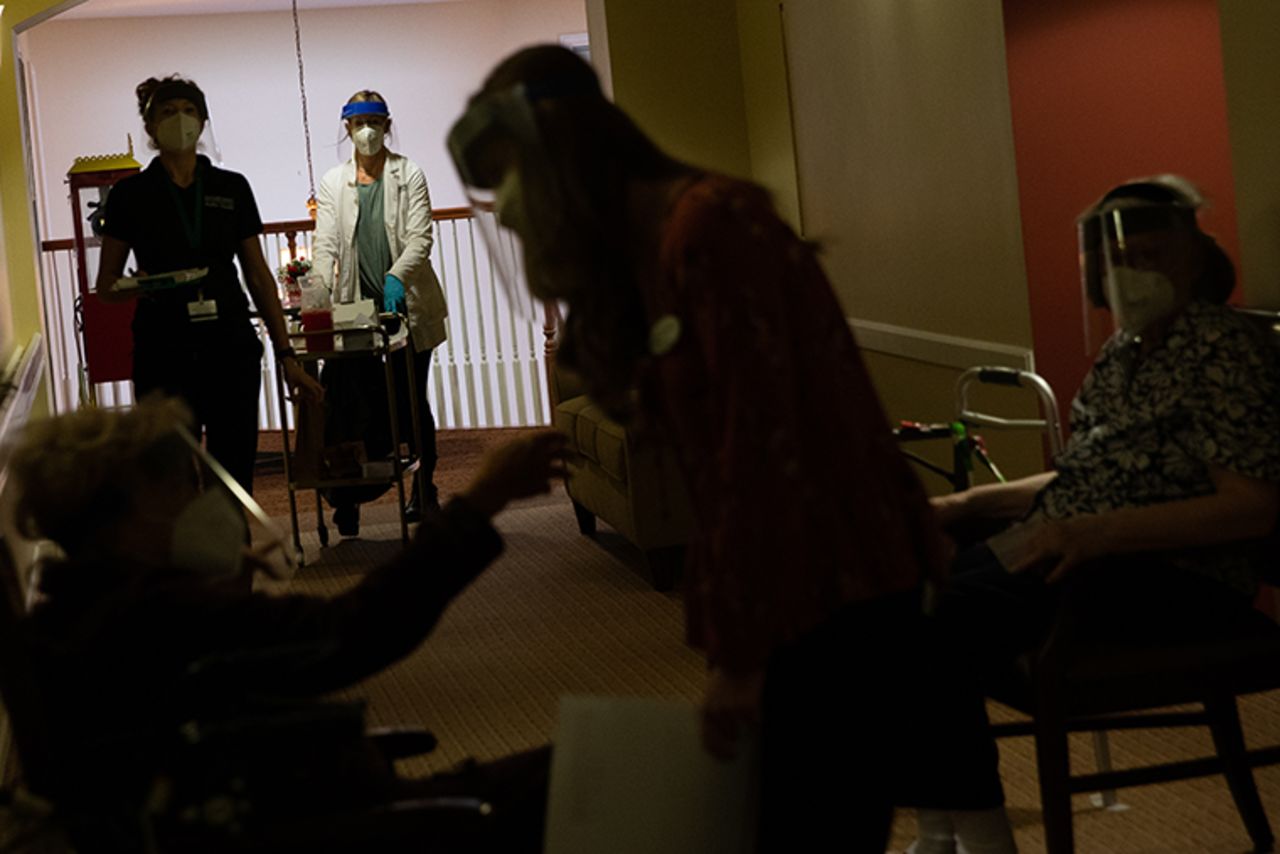 Healthcare workers arrive to distribute second doses of the Pfizer BioNtech Covid-19 vaccine to residents at a senior living facility in Bloomfield Hills, Michigan, U.S., on Friday, Jan. 22, 2021. 