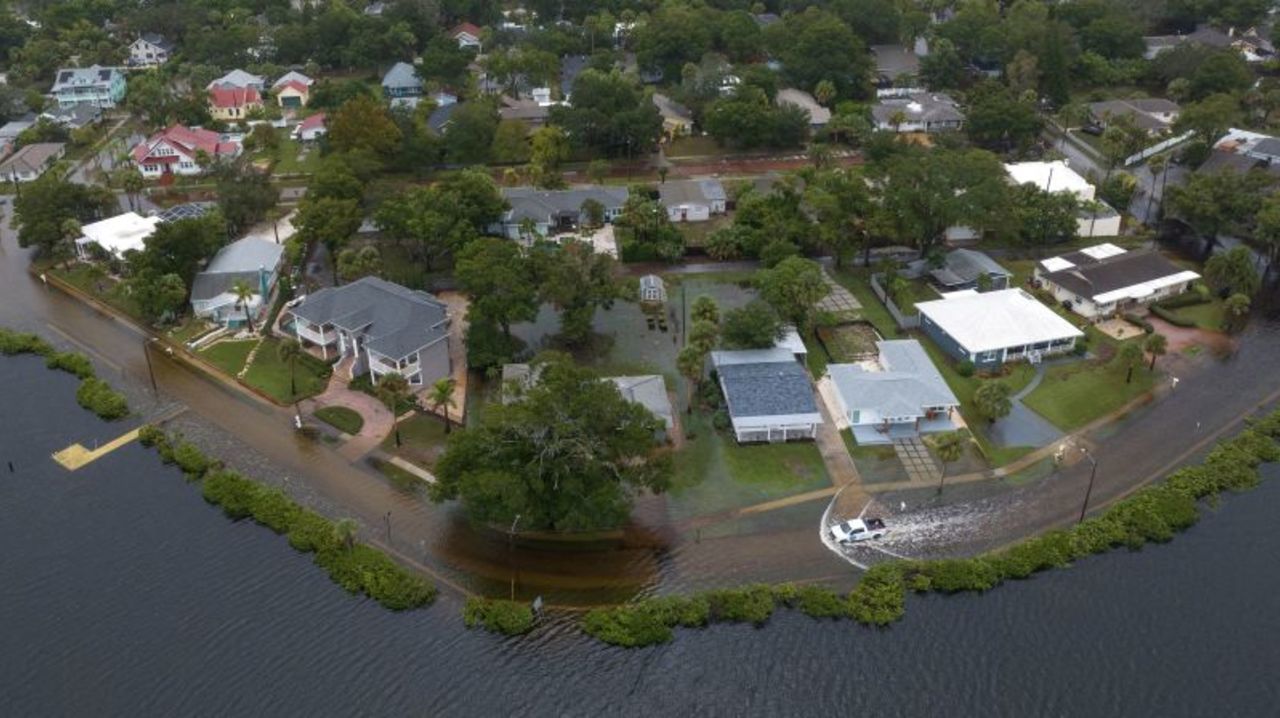 A vehicle moves through flood waters in the aftermath of Hurricane Idalia in Tarpon Springs, Florida, on Wednesday. 