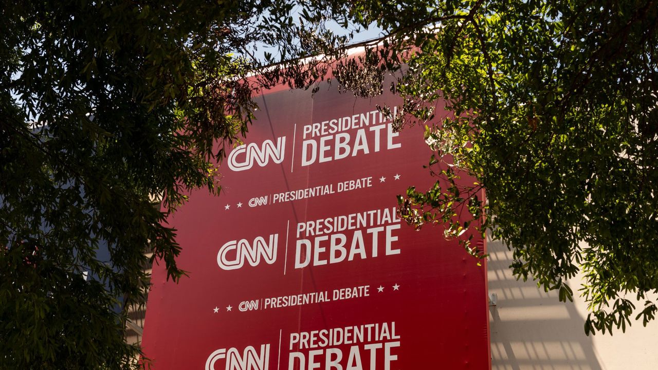 Banners hang outside of CNN’s Atlanta headquarters ahead of CNN’s Presidential Debate between President Joe Biden and former President Donald Trump on June 24.