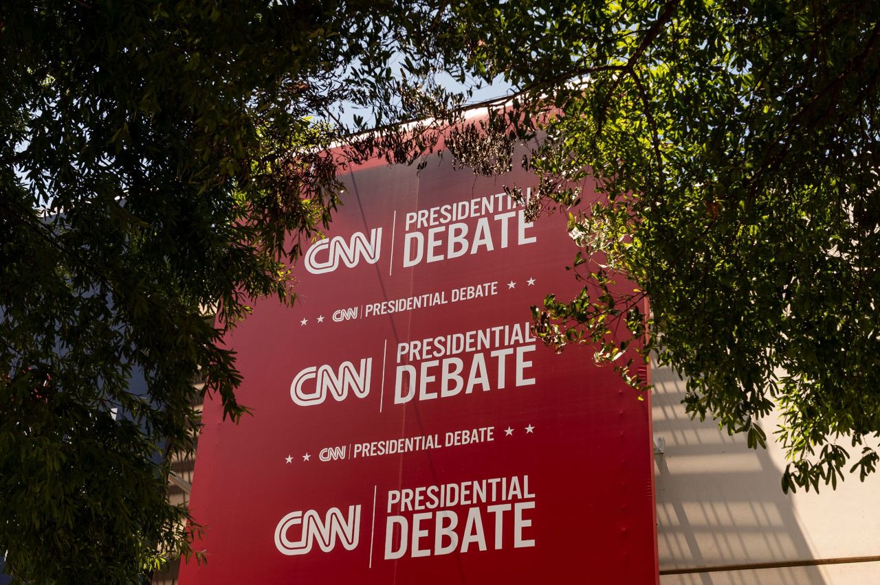 Banners hang outside of CNN’s Atlanta headquarters ahead of CNN’s Presidential Debate between President Joe Biden and former President Donald Trump on June 24.