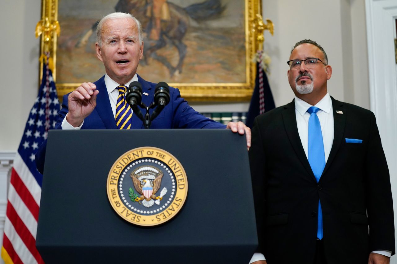 President Joe Biden speaks about student loan debt forgiveness alongside Education Secretary Miguel Cardona.